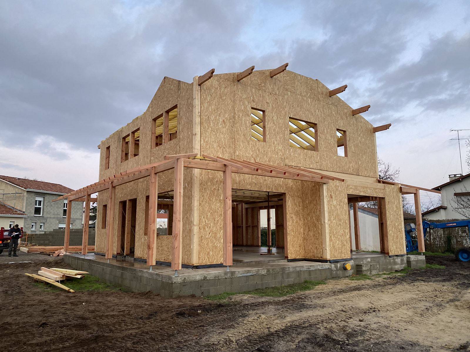 Réalisation d'une maison ossature bois avec coursive sur poteaux sur la périphérie.