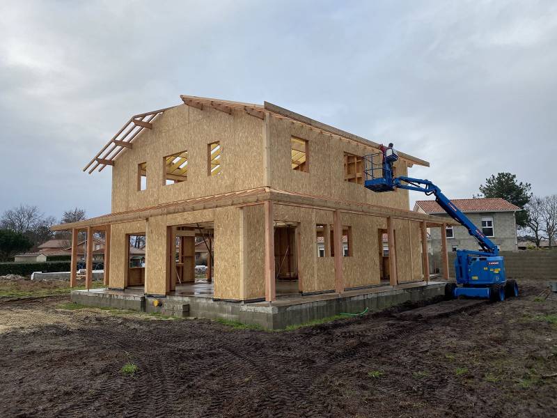 Pose de bandeaux bois sur une charpente traditionnelle à l'aide d'une nacelle dans les Landes